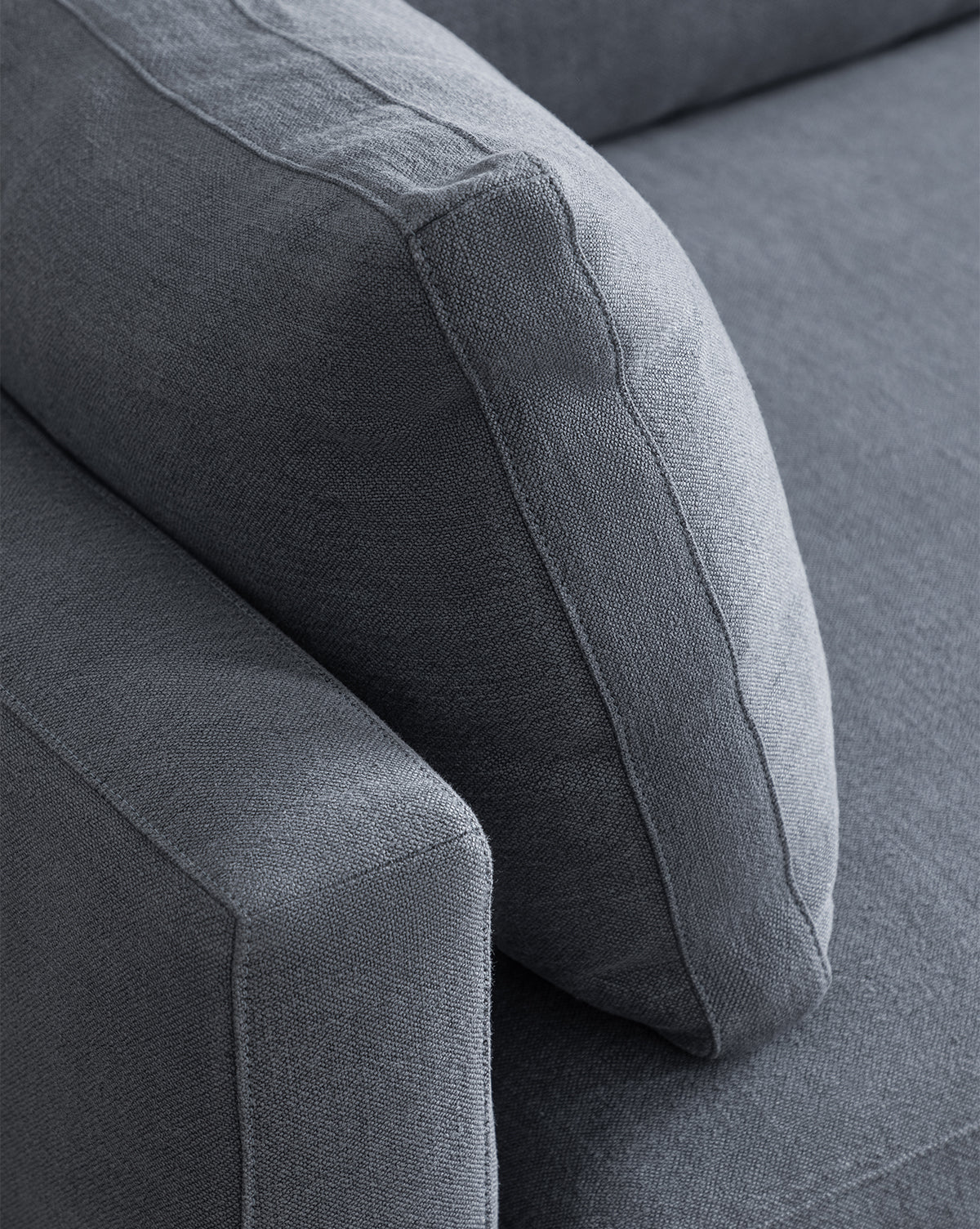 Close-up of the Peterson Classic Upholstered Sofa (75 - 100) in gray, highlighting the armrest, plush cushions, and backrest cushion with visible stitching and textured upholstery by McGee & Co.