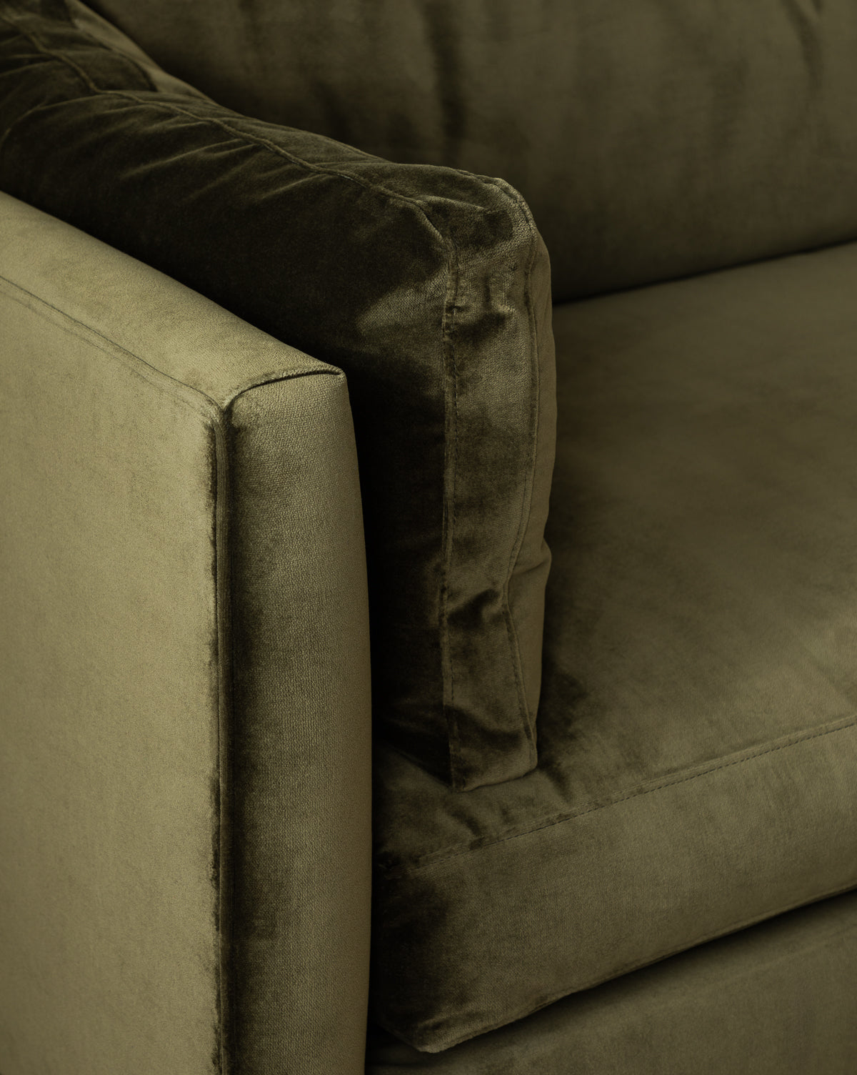 Close-up of the Haverford Upholstered Sofa 90 in plush olive green velvet, highlighting the armrest, seat, and back cushion with a soft fabric texture. This handcrafted piece blends elegant comfort with timeless style, by McGee & Co.