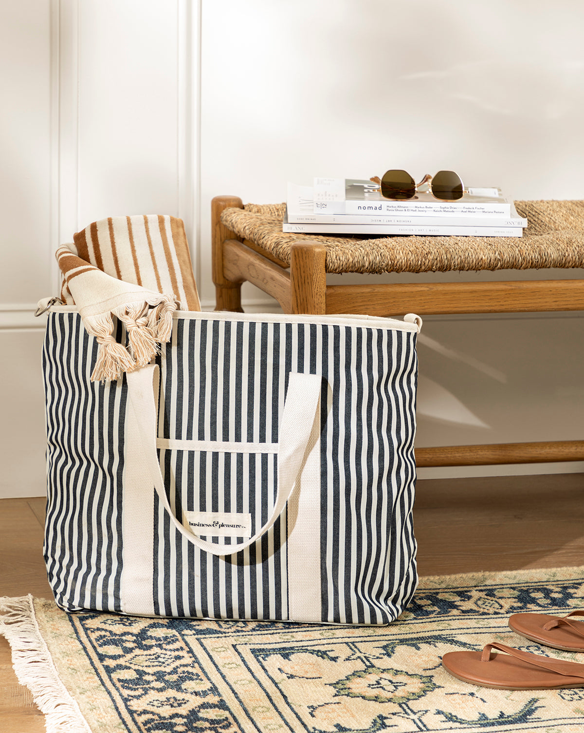 Navy Striped Cooler Bag with padded sides and waterproof interior, shown in a home entryway, from McGee & Co.