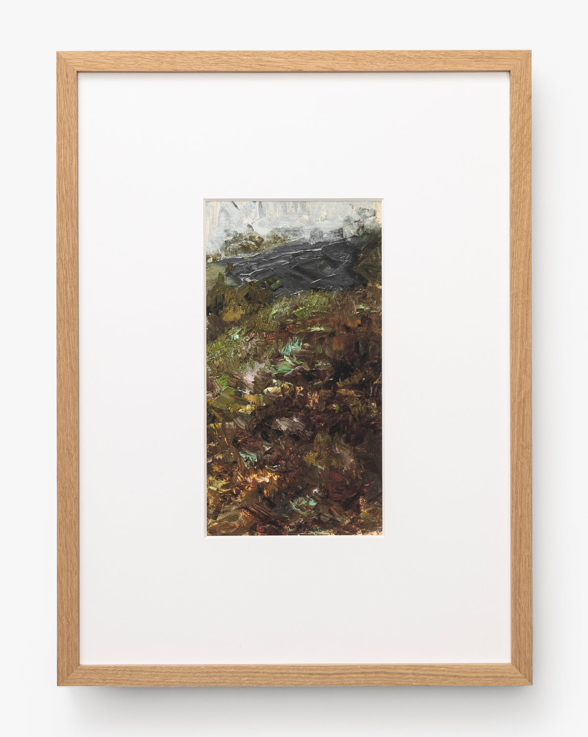 A River Runs Through is a framed abstract painting with earthy browns, greens, and dark grays, featuring textured brushstrokes. Centered within a large white mat and light wood frame, it evokes abstract landscapes by McGee & Co.