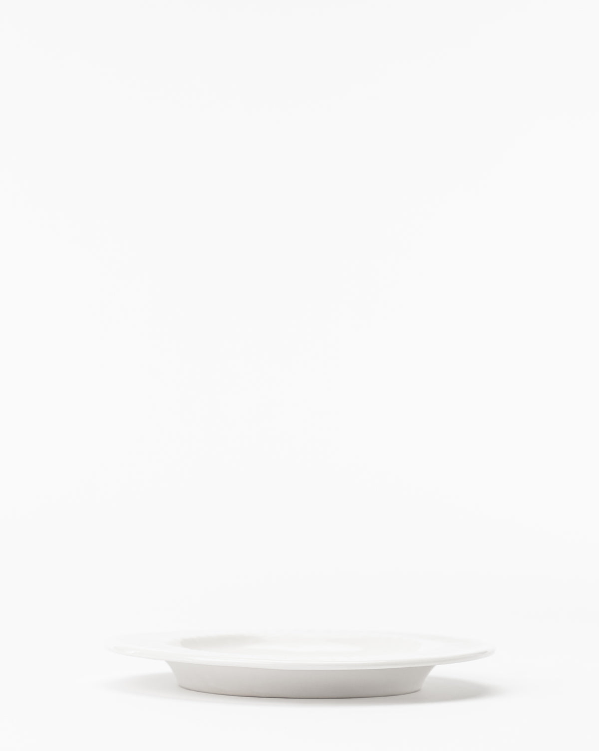 The Adele White Salad Plate (Set of 4) sits centered on a white background, offering timeless and versatile dinnerware with ample negative space above for a clean, modern look, by McGee & Co.