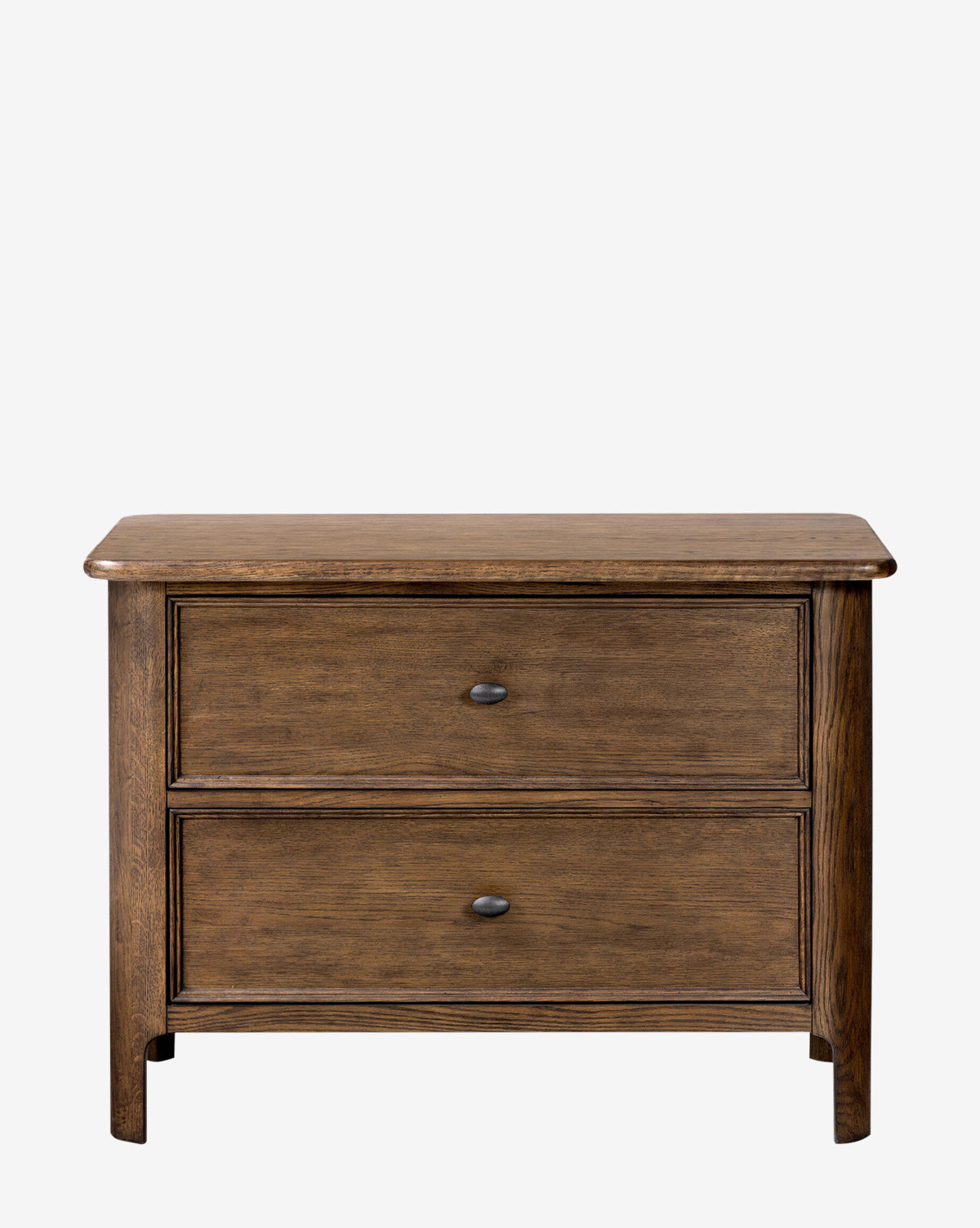 The Aeris Nightstand by Four Hands is a wooden two-drawer dresser with curved edges and dark metal knobs, ideal for bedroom organization or as a nightstand, shown standing on short legs against a plain white background. McGee & Co.