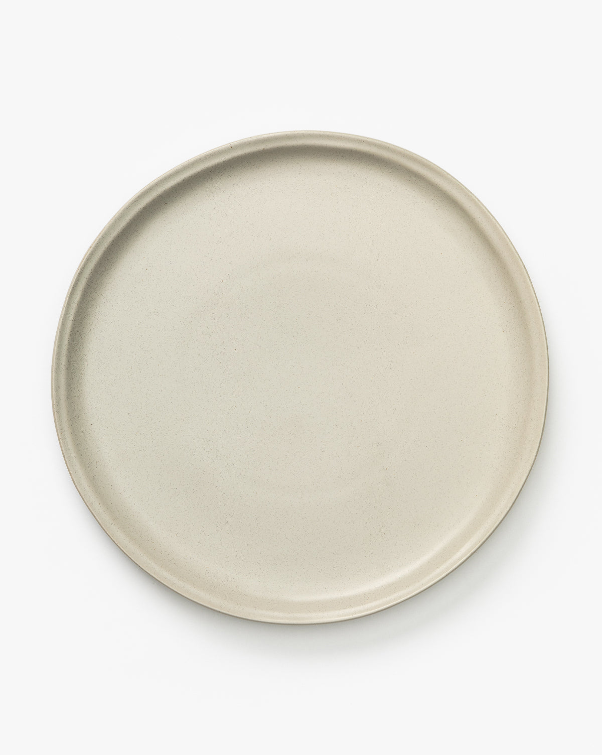 The Aiden Soft Gray Dinner Plate, a plain, round, glazed ceramic plate in soft gray, is shown from above on a white background, by McGee & Co.