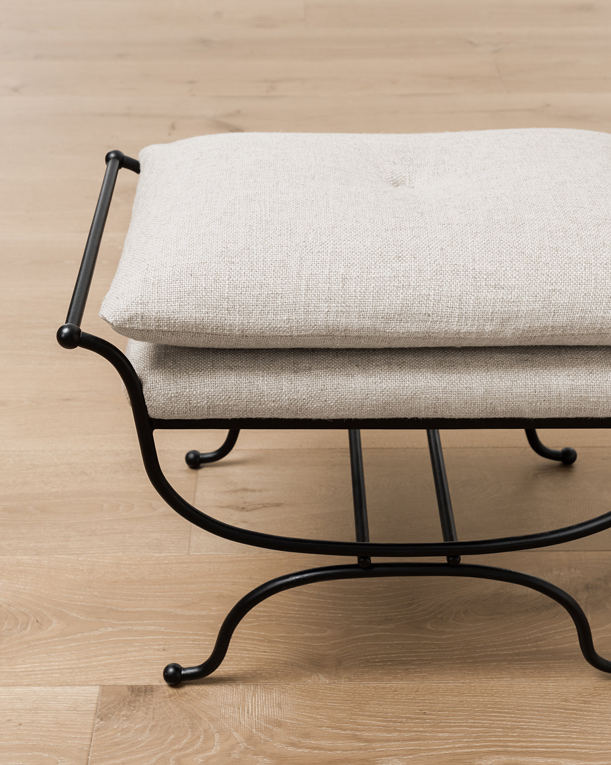 Certainly! Here’s your sentence with the exact string McGee & Co. blended at the end: A close-up of the Makerspalm Alameda Stool, showcasing its linen upholstered cushion and matte black iron base on a light wooden floor, by McGee & Co. If you prefer to keep it as an addition rather than attribution, you could use: A close-up of the Makerspalm Alameda Stool, showcasing its linen upholstered cushion and matte black iron base on a light wooden floor. McGee & Co.