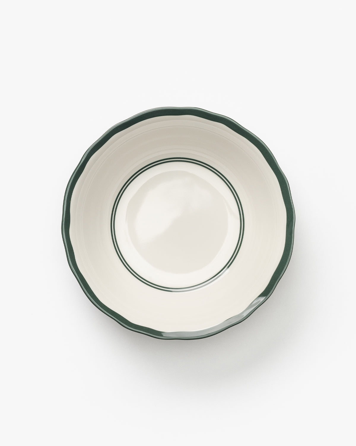 A set of four cream-colored Alcott Melamine Bowls, each with a scalloped edge and dark green trim, made from BPA-free melamine, shown from above on a white background by McGee & Co.