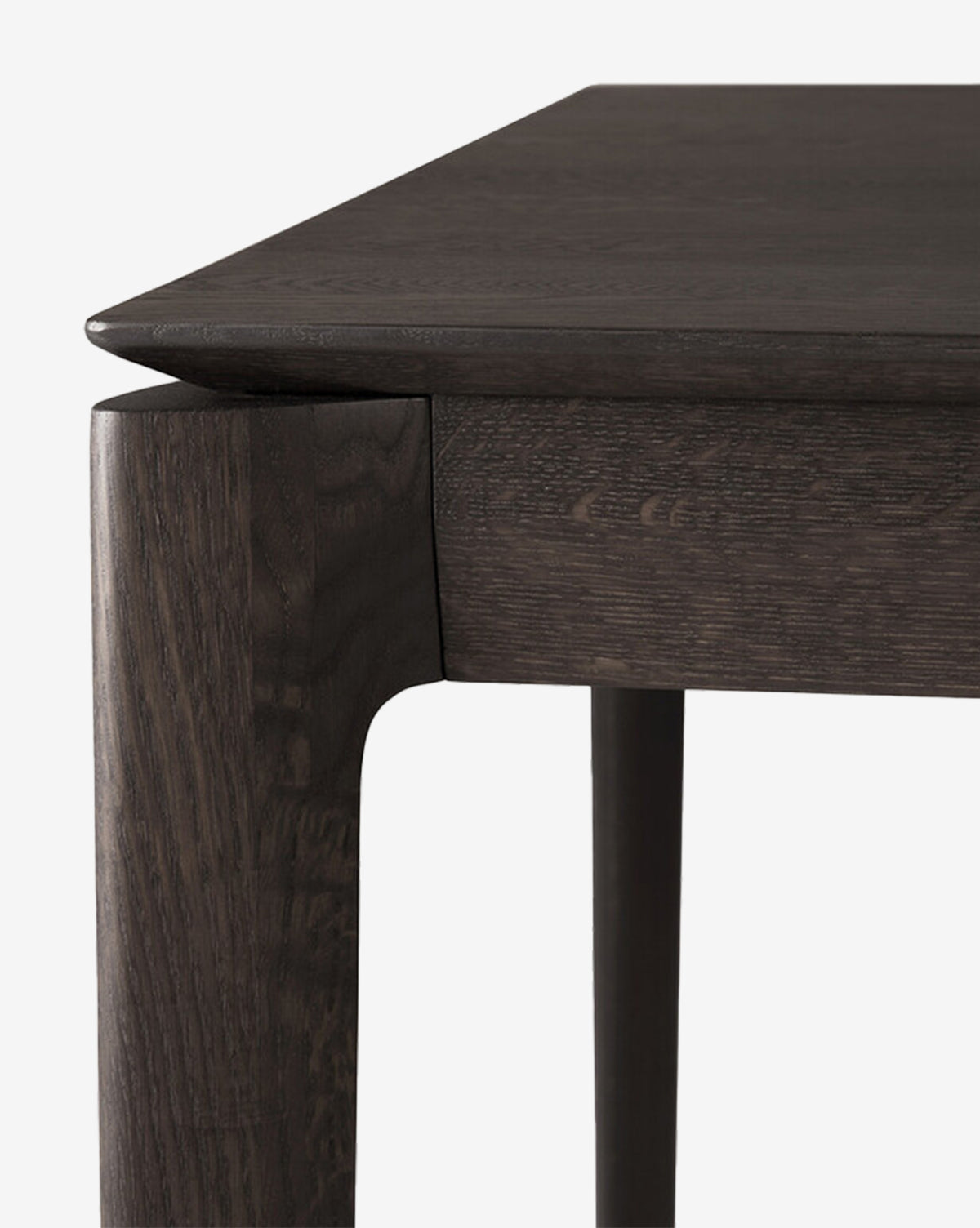 Close-up of the Alec Dining Table’s corner highlights its sturdy build, smooth edges, and clean, modern lines against a white background—an ideal addition to any dining room, by McGee & Co.