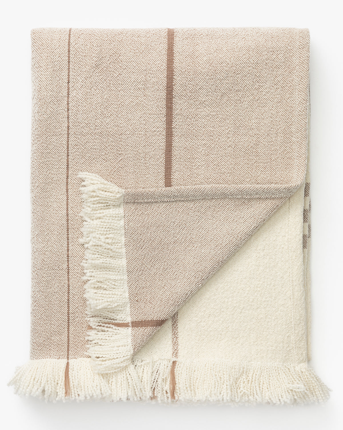 The Alex Plaid Throw by ILA HOME FASHIONS, shown folded on a white background, features a luxurious beige and cream palette with thin brown stripes and fringed edges, McGee & Co.
