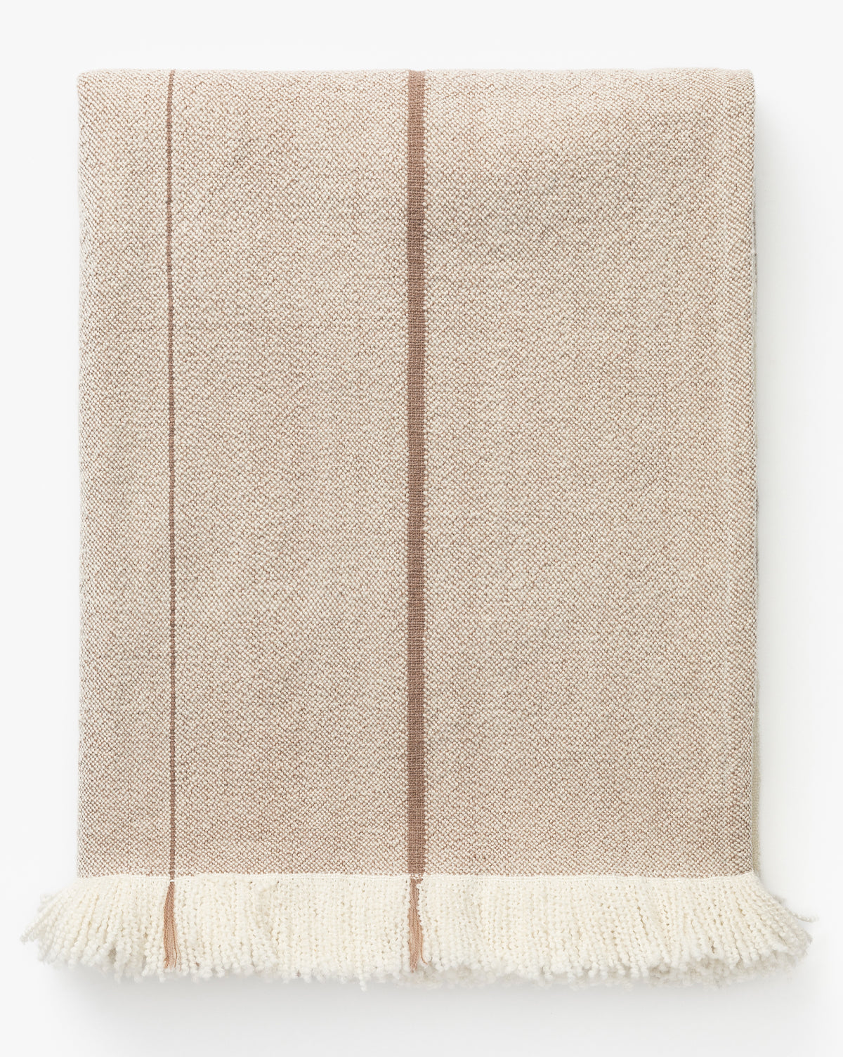 The Alex Plaid Throw by ILA HOME FASHIONS features a beige herringbone weave with a brown vertical stripe and fringed white edges, offering a neutral palette reminiscent of cozy luxury by McGee & Co.