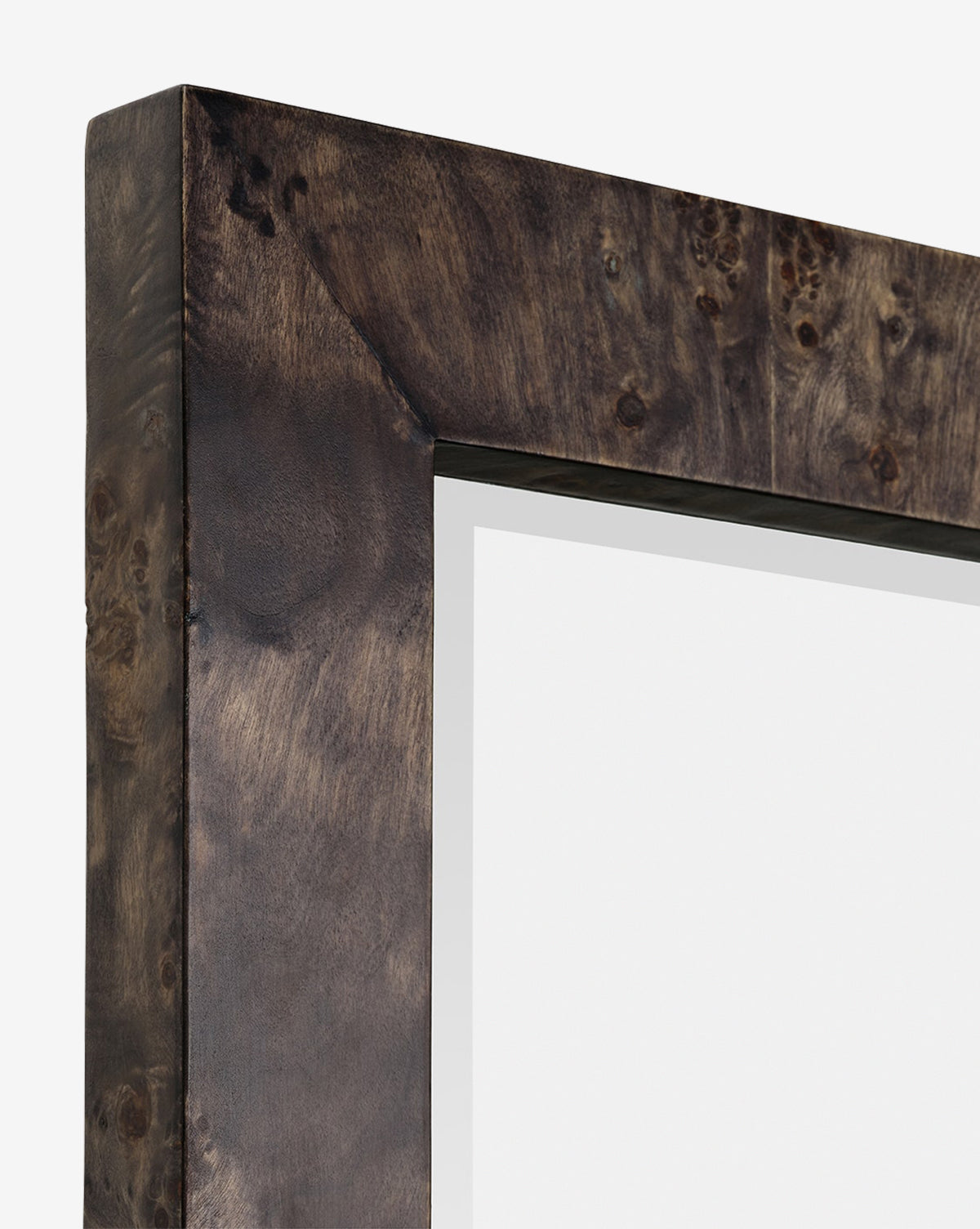 Close-up of the top left corner of the Alexia Rectangular Mirror, crafted from dark, textured burl wood and featuring a blank reflective surface—a refined statement piece for any space, by McGee & Co.