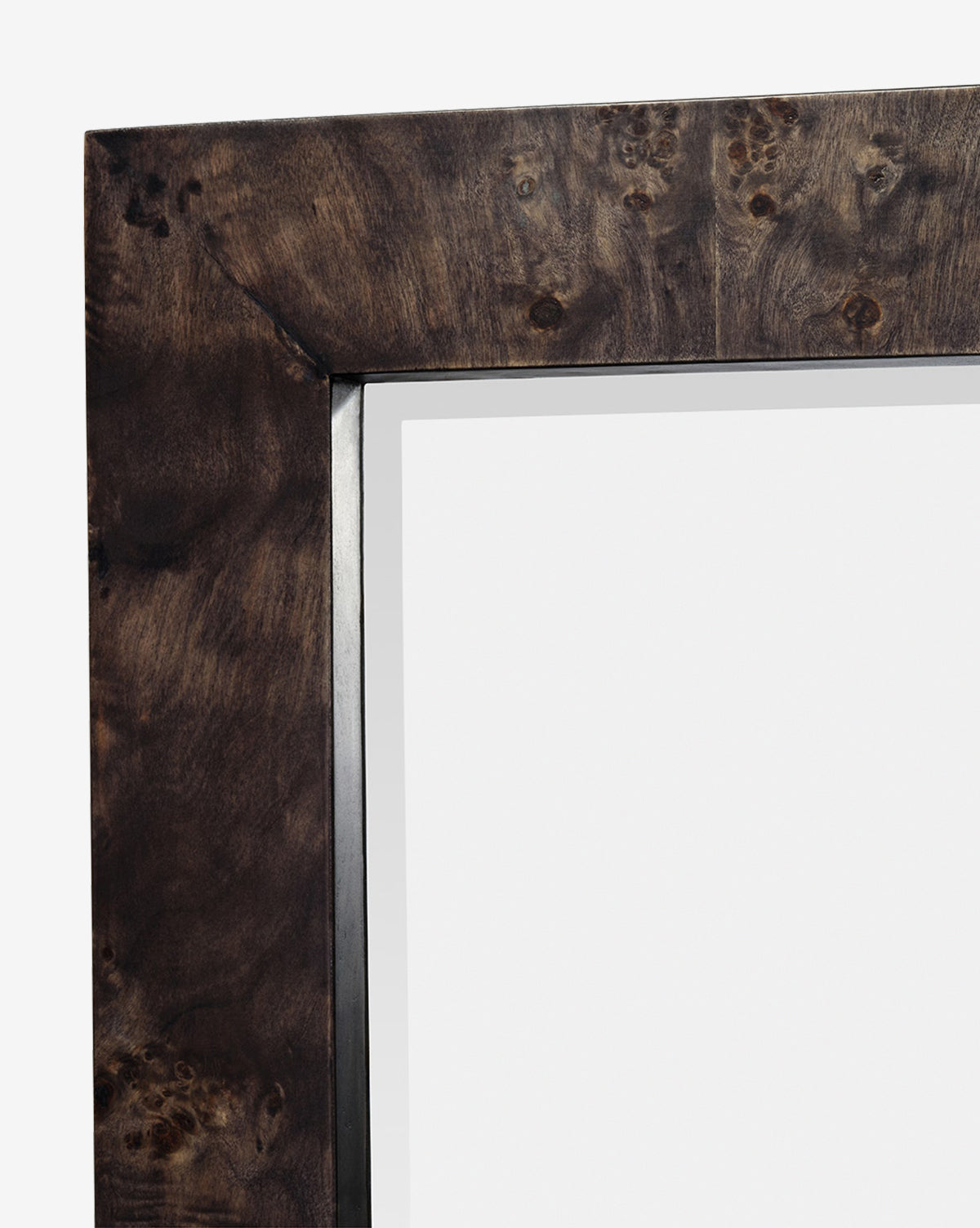 Close-up of the top left corner of the Alexia Rectangular Mirror, featuring a dark burl wood-grain frame with a glossy finish and blank white background—an ideal statement piece for any space, by McGee & Co.