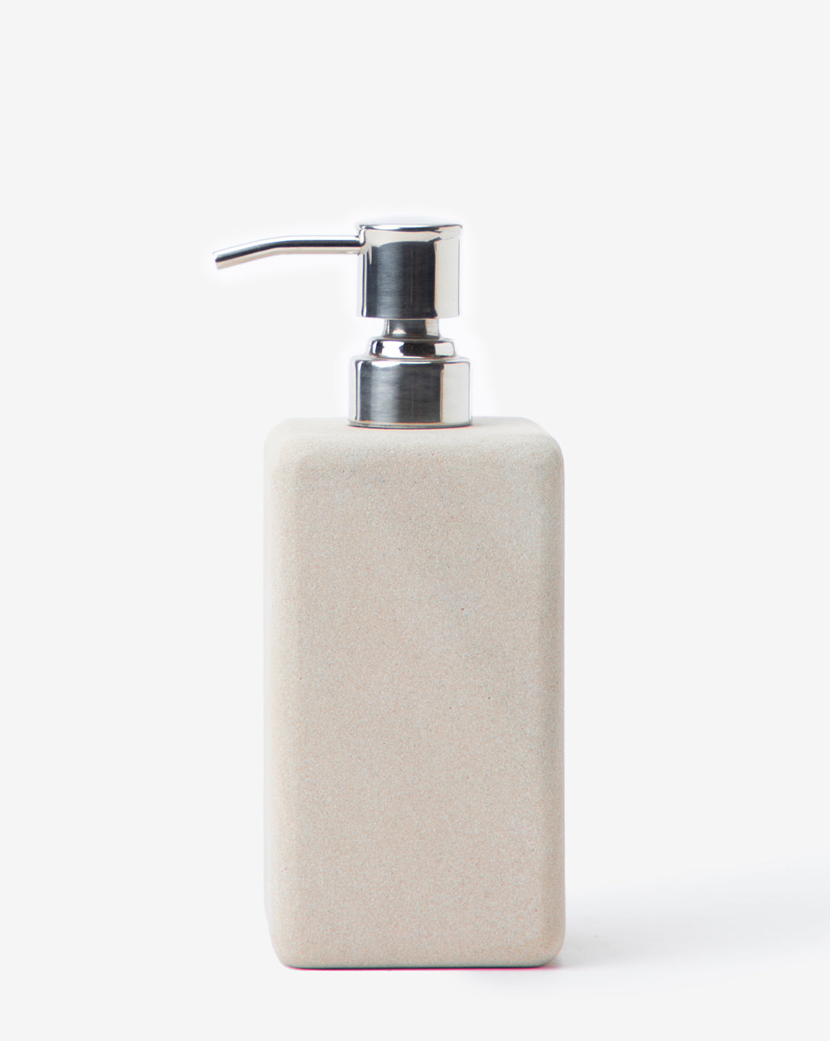 The Amada Sandstone Bath Collection soap dispenser, featuring a rectangular beige design with a metallic pump, adds an organic touch to your bathroom decor.