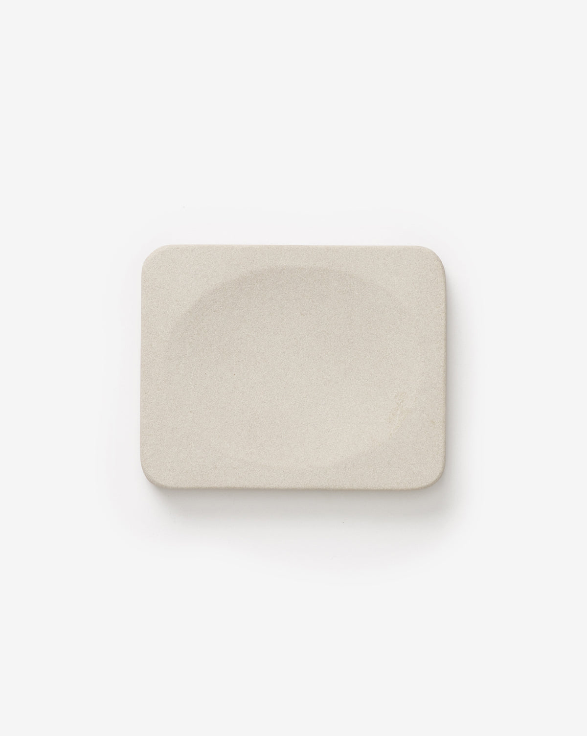 Rectangular, off-white soap bar with smooth edges and a gentle center dip from the Amada Sandstone Bath Collection—brings an organic feel to your bathroom. Shown on a plain white background.