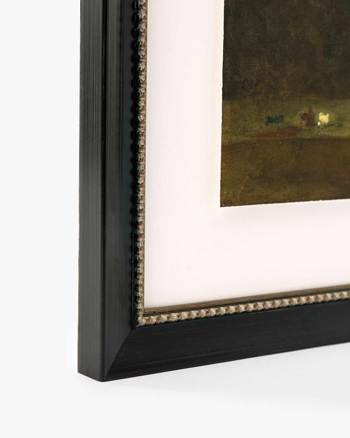 Close-up of the corner of a framed giclee print titled Antique Flower Vase with a black, textured frame and white mat showcasing part of the artwork in rich, dark, earthy tones by McGee & Co.