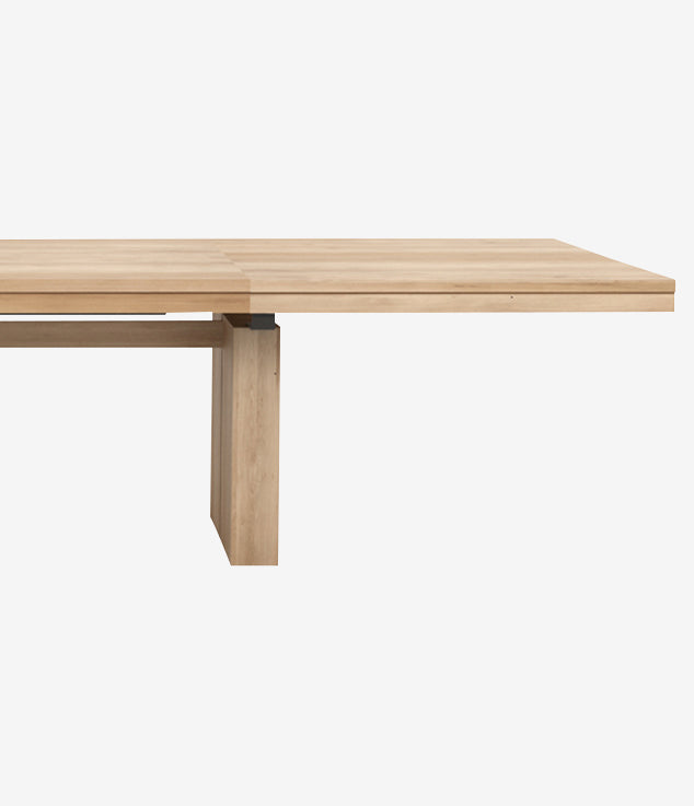 The Antoni Extension Dining Table is crafted from solid wood with a light natural finish, clean lines, and sturdy rectangular legs. Shown on a white background, this extendable table adds style and versatility to any dining space.