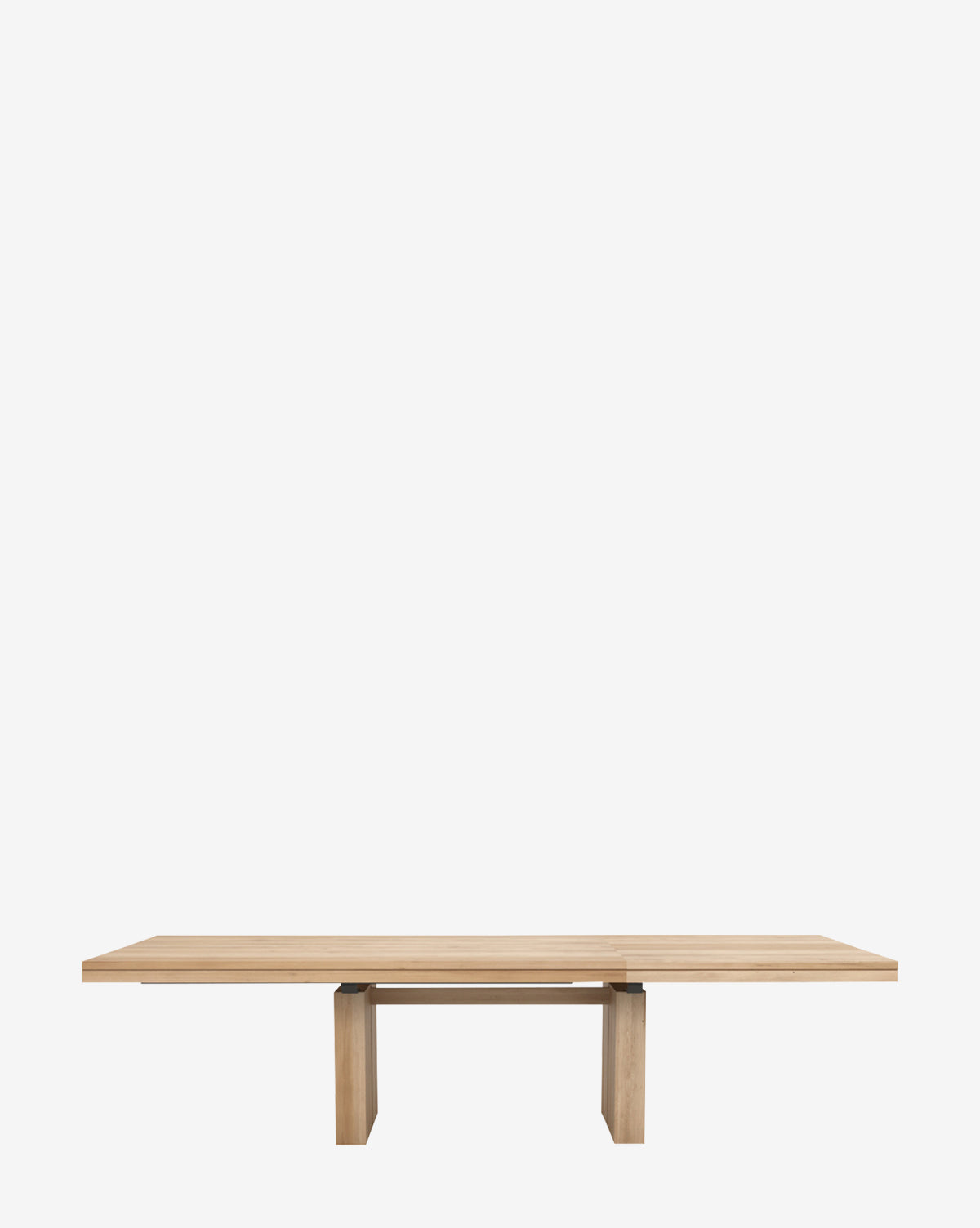 The Antoni Extension Dining Table is a minimalist, rectangular solid wood table with a light finish, flat top, and sturdy block-style legs, showcased against a plain white background.