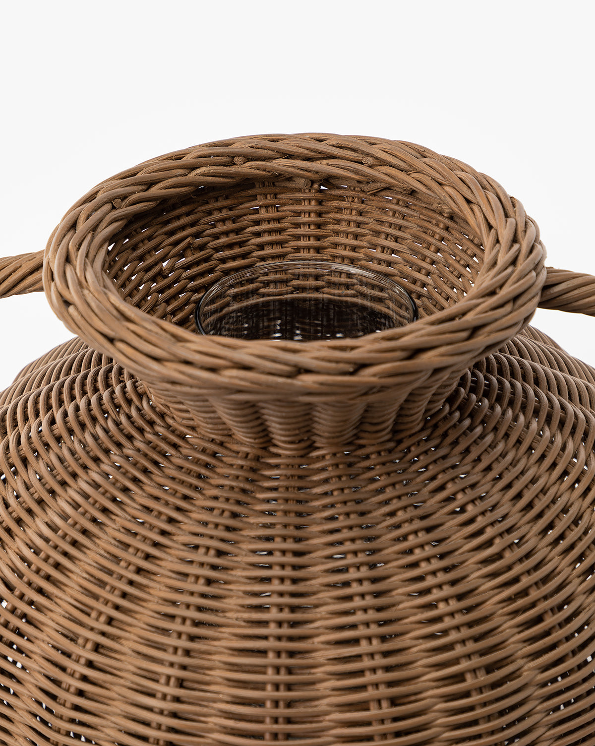 Close-up of the top of the Antonia Woven Vase, featuring a glass insert and showcasing the detailed texture and circular pattern of the woven material.