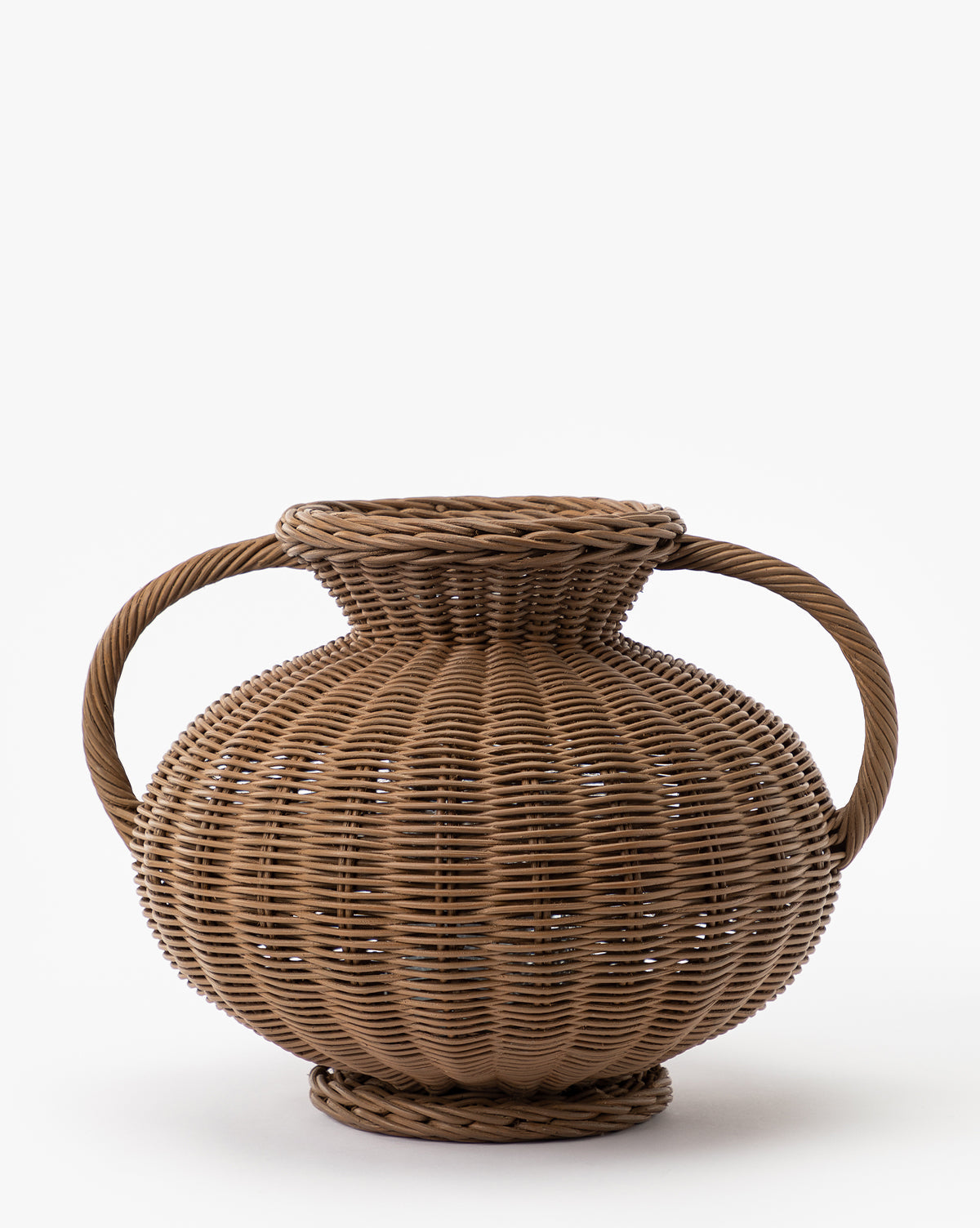 The Antonia Woven Vase is a round, brown wicker basket with two large side handles and a wide top opening, displayed on a plain white background.