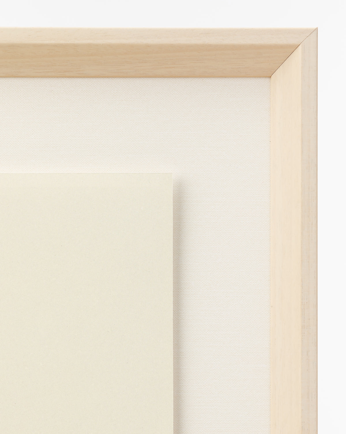A close-up of a light wooden picture frame with an off-white mat and cream-colored paper displays the Apple Collage giclee print—perfect for children’s room art and shown against a white background, by McGee & Co.