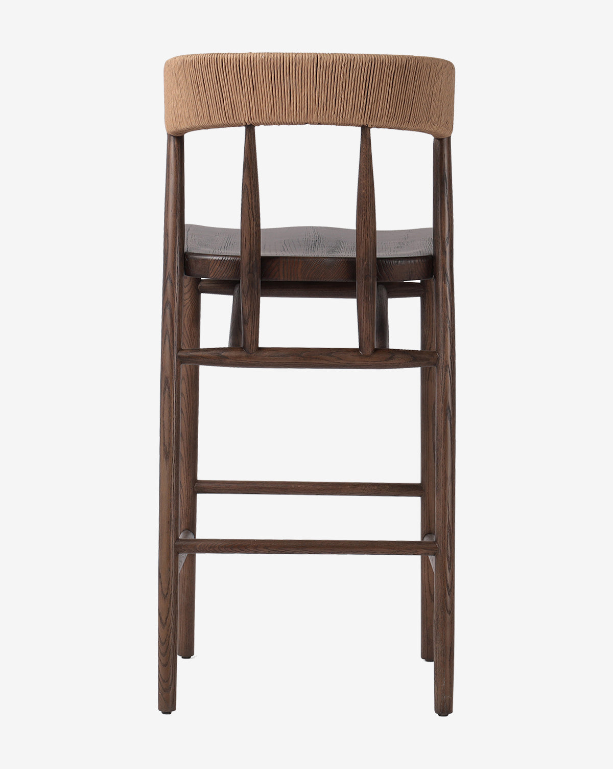 The Ardent Stool by Four Hands features a curved natural paper rush woven backrest with three vertical supports and a dark oak frame, showcased from the back against a white background. McGee & Co.