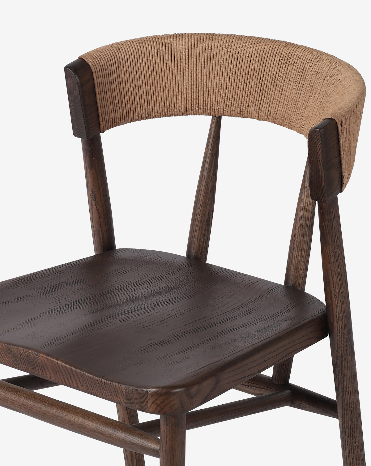 The Ardent Stool by Four Hands features a solid oak frame with dark brown seat and legs, a curved backrest wrapped in light tan woven material, and a modern minimalist design—perfect for any kitchen bar. McGee & Co.