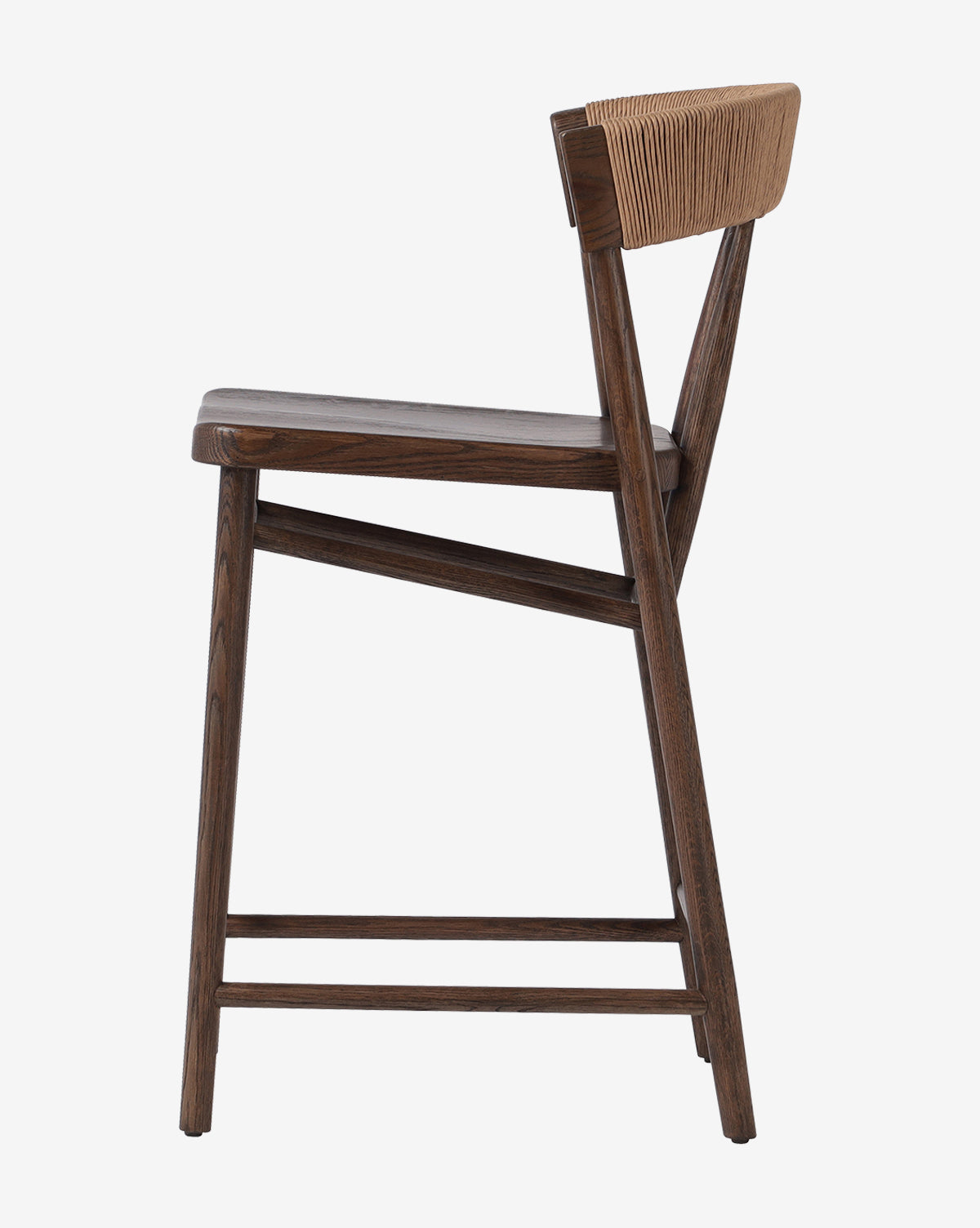 Side view of the Four Hands Ardent Stool featuring a solid oak frame, angled legs, gently curved seat, and a woven light tan backrest—ideal for any modern kitchen bar. McGee & Co.