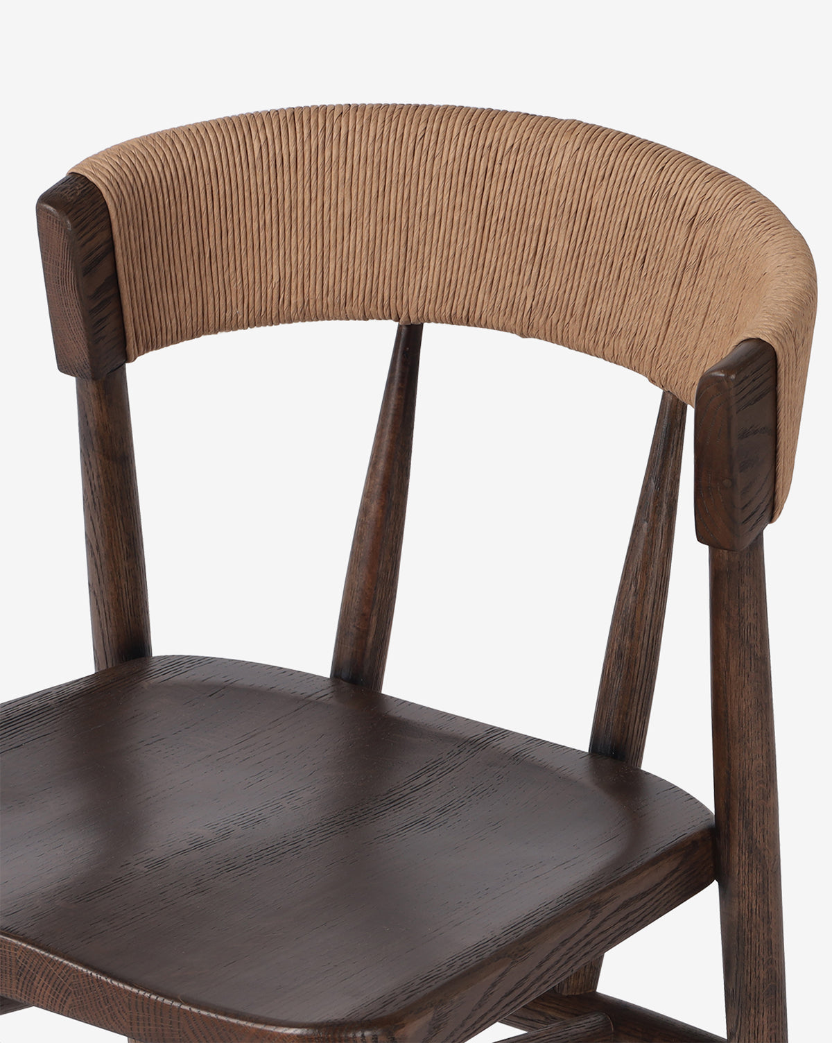 The Ardent Stool by Four Hands is a wooden kitchen bar stool with an oak frame, dark brown seat, and a curved backrest wrapped in natural paper rush for added texture and style by McGee & Co.