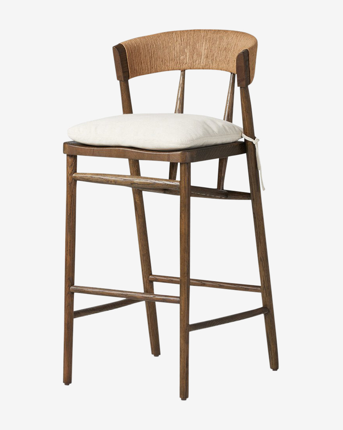 The Ardent Stool by Four Hands features an oak frame, a curved woven natural paper rush backrest, a light cushion tied to the seat, and four straight legs with supports for a timeless blend of natural wood and neutral tones. McGee & Co.
