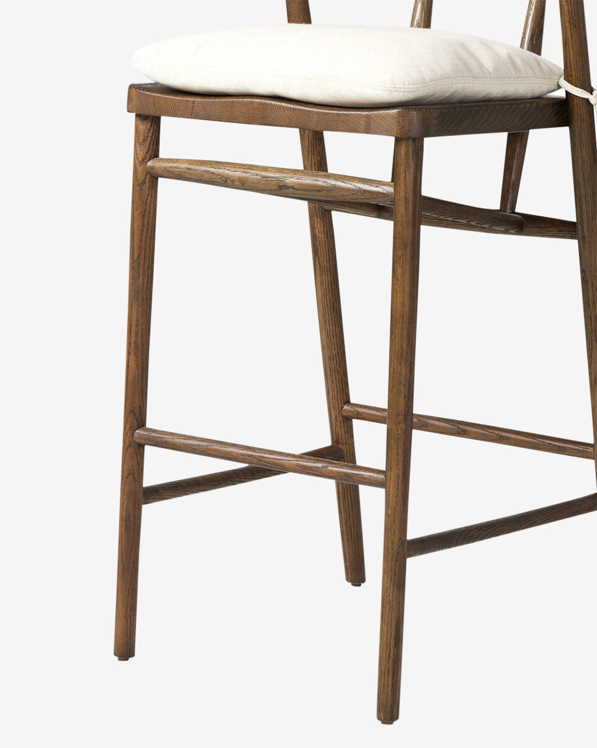 The Four Hands Ardent Stool features a solid oak frame, straight legs, and horizontal support bars with a light cushioned seat—photographed against a white background—ideal for your kitchen bar. McGee & Co.