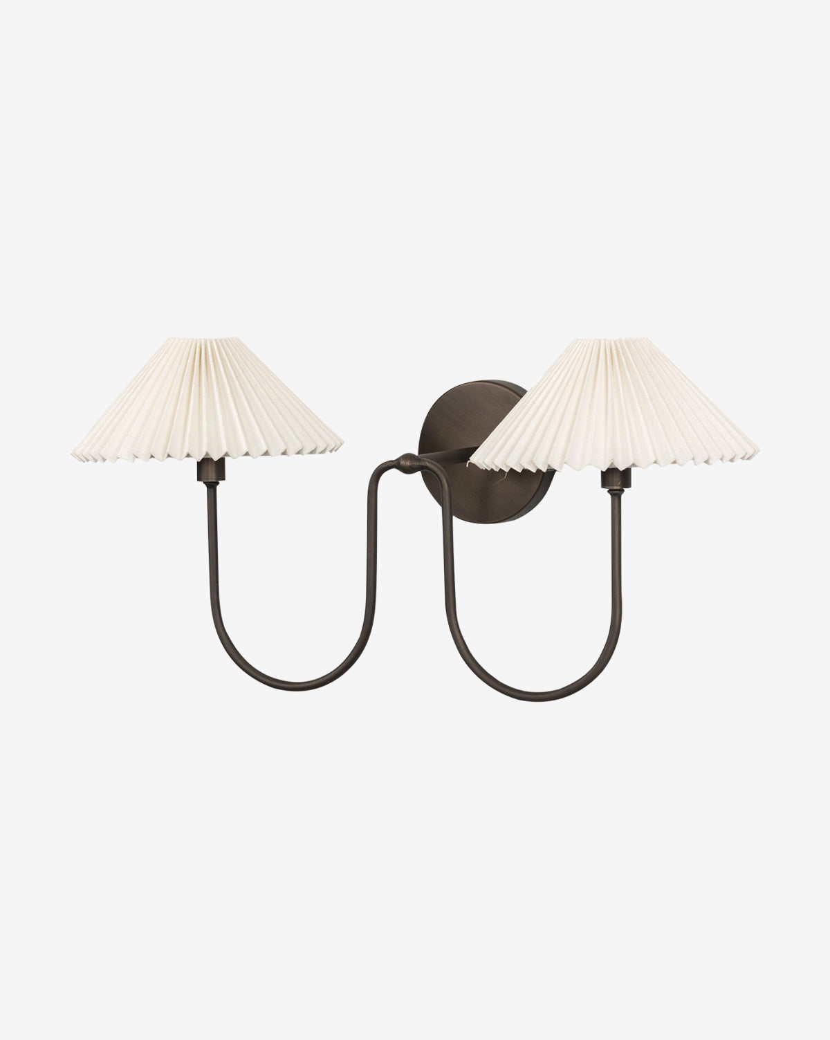 The Four Hands Ashby Double Sconce features two curved black metal arms in an oil-rubbed bronze finish with pleated white linen shades, offering a symmetrical look against a plain white background. McGee & Co.