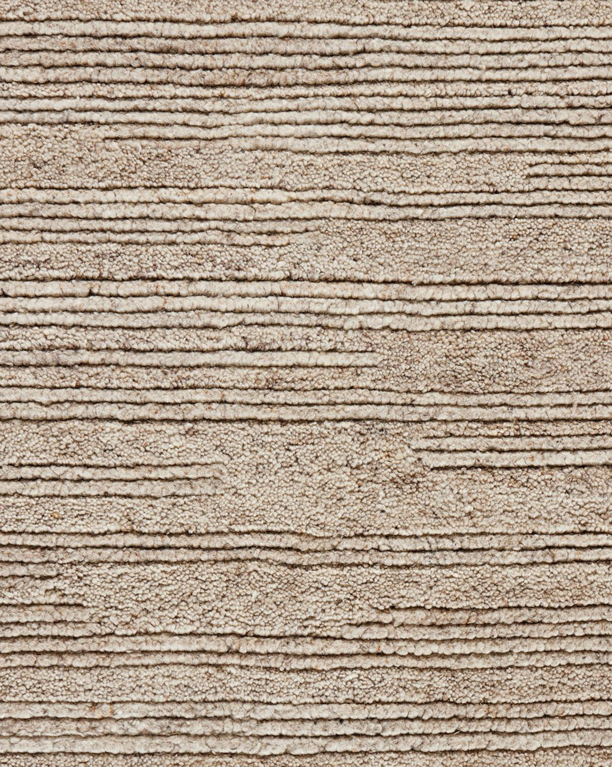 A close-up of the Ashwin Hand-Knotted Wool Rug shows its beige, textured neutral palette with horizontal, unevenly spaced ridges and lines, creating a soft and patterned look, by McGee & Co.