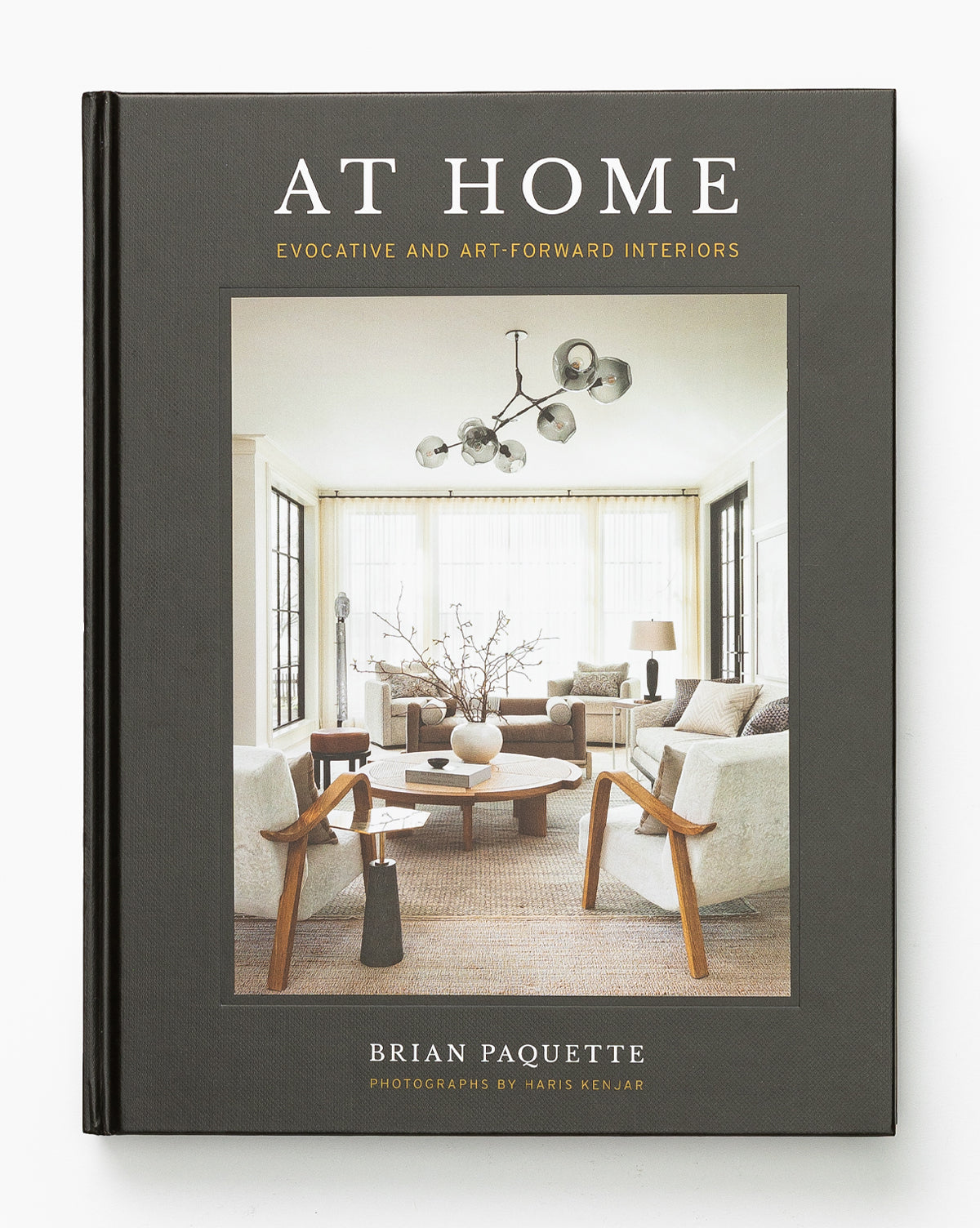 At Home by Brian Paquette showcases a cover with a modern living room, highlighted by neutral tones and contemporary furniture, reflecting inspiring and art-forward interior design.