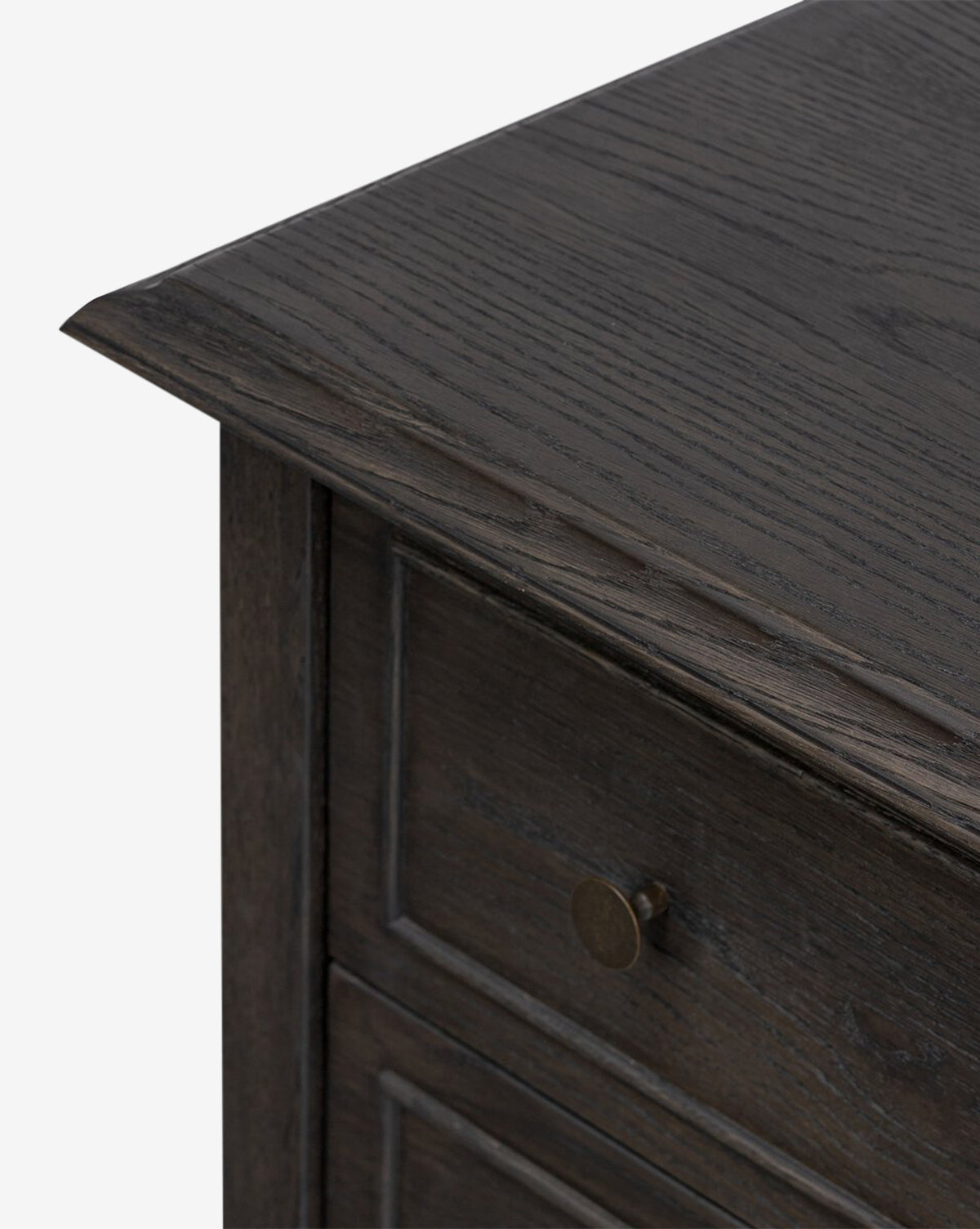 Close-up of the top corner and upper drawer of the Aurelian Nightstand, showcasing its refined wood grain and round metal drawer pull—an elegant storage solution for any bedroom, by McGee & Co.