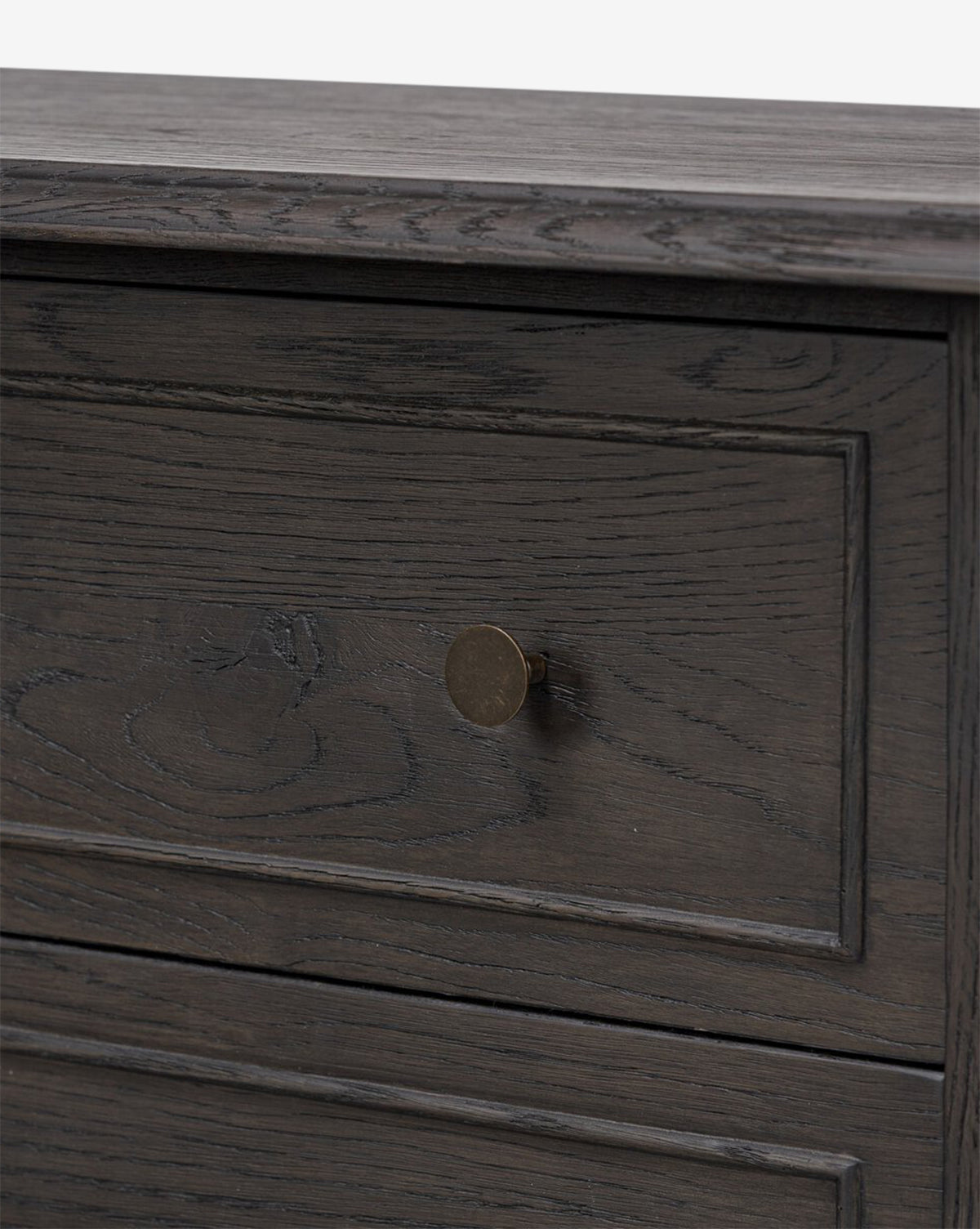 Close-up of the Aurelian Nightstand in smoked oak, highlighting its elegant wood grain and round brass knob—an ideal choice for stylish bedroom storage, by McGee & Co.