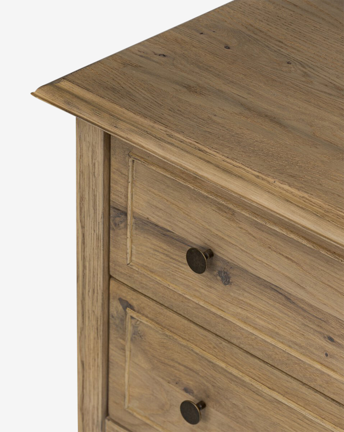 Close-up of the Aurelian Nightstand’s top corner in smoked oak, highlighting two drawers with round dark metal knobs and a rustic, natural wood grain—an ideal choice for stylish bedroom storage by McGee & Co.