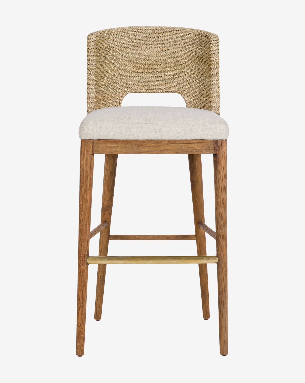 The Ava Seagrass Counter Stool features a hand-woven seagrass backrest, beige cushioned seat, teak frame legs, and a brass footrest, displayed against a plain white background.