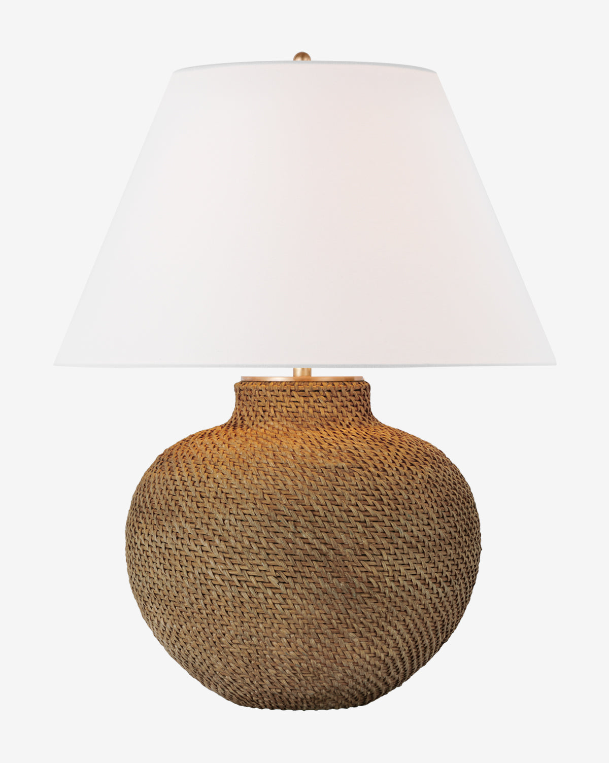 The Avedon Table Lamp has a round, textured rattan base with a large white linen shade, shown against a plain white background by McGee & Co.