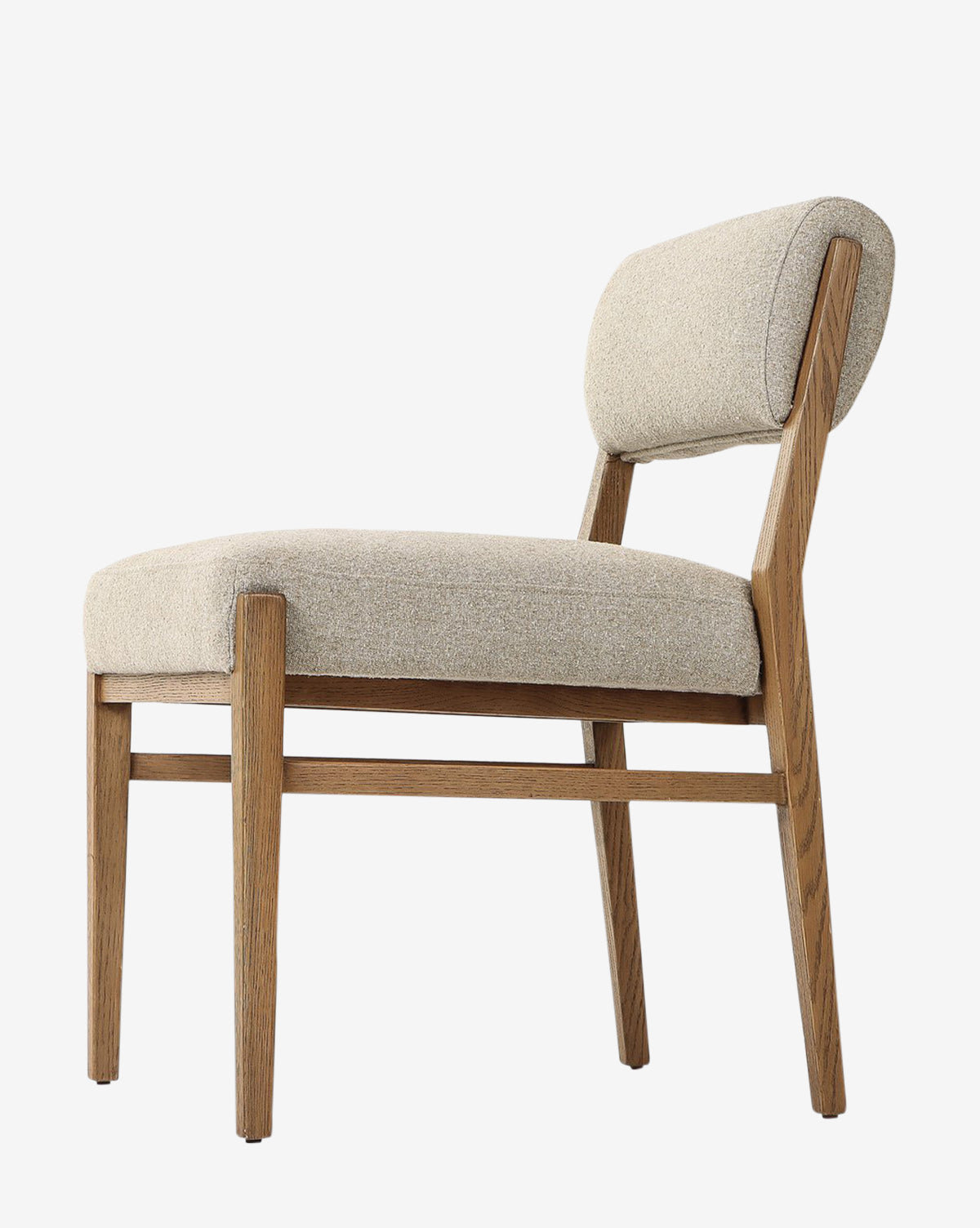 The Bailey Dining Chair features a light beige upholstered seat and backrest, an angled smoked oak frame with straight lines, shown against a white background by McGee & Co.