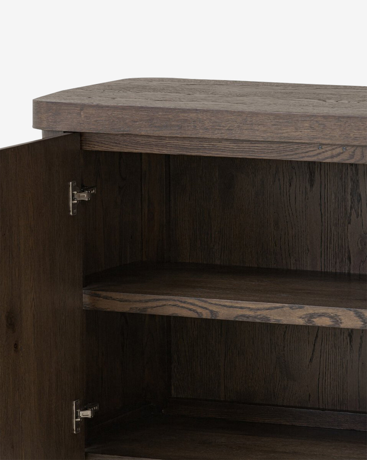 A close-up of the Baldwin Sideboard, showing its brown oak finish, textured surface, one interior shelf, and a left-side hinged door in a simple, modern design by McGee & Co.