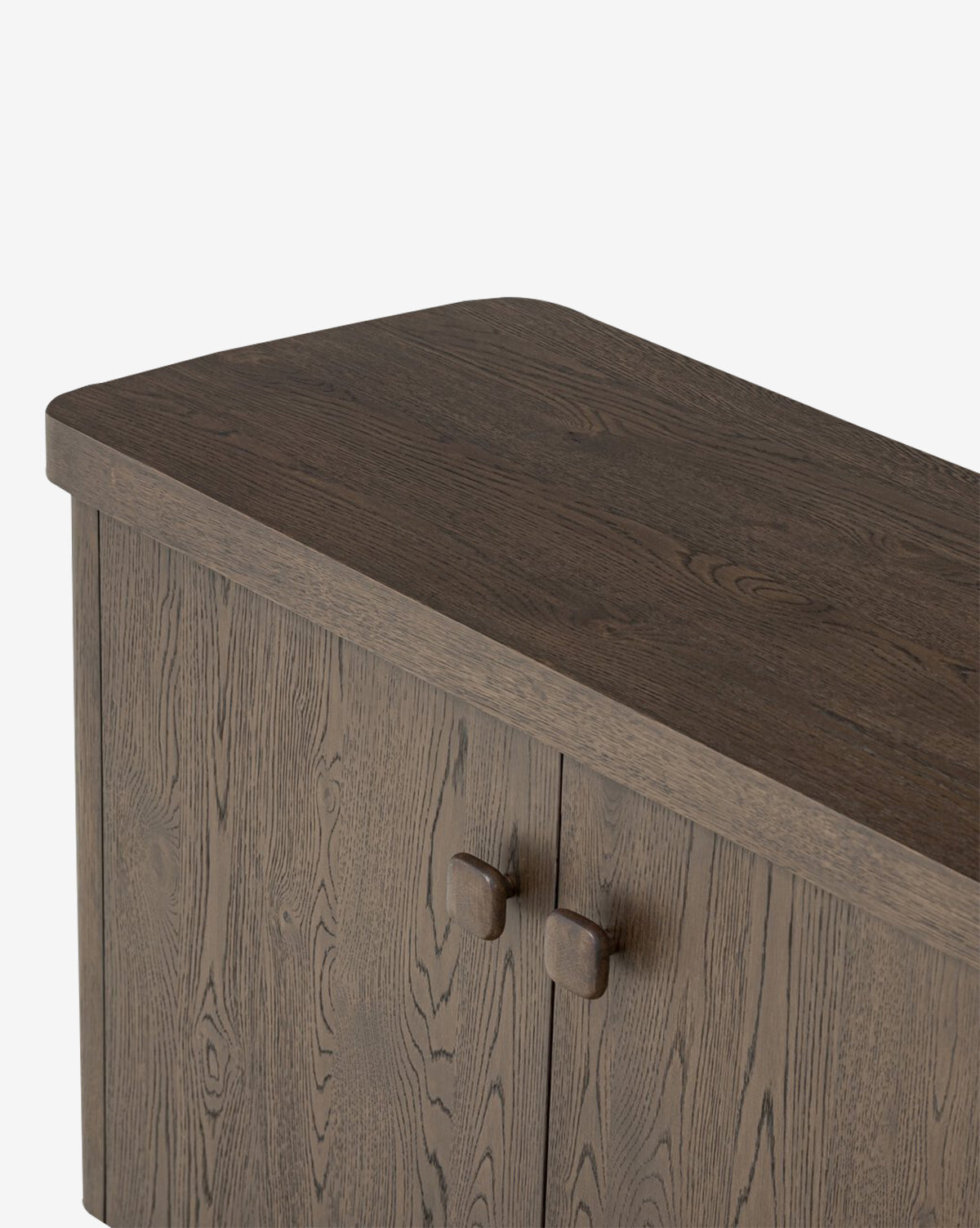 Close-up of the Baldwin Sideboard, showcasing its dark oak veneer finish, rounded top edges, and two square-knobbed doors, set against a plain white background by McGee & Co.