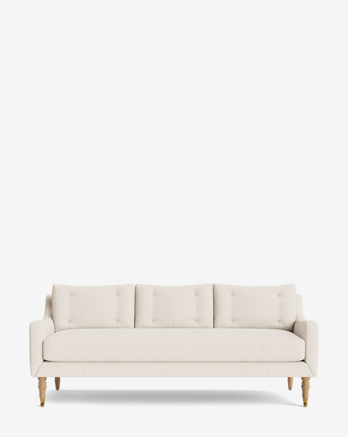 The Barden Sofa 84 is a modern cream sofa with three seat and back cushions, reeded wood legs, and a minimalist look, shown against a plain white background by McGee & Co.