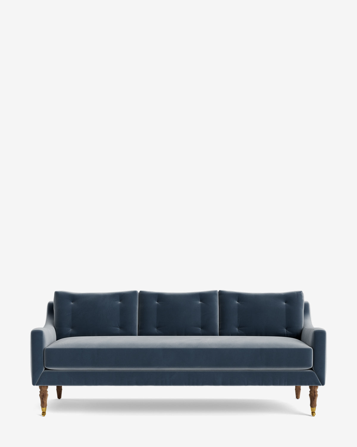 The Barden Sofa 84 showcases a modern navy blue velvet look with three back cushions, slim arms, and reeded wood legs with brass casters, set against a plain white background by McGee & Co.