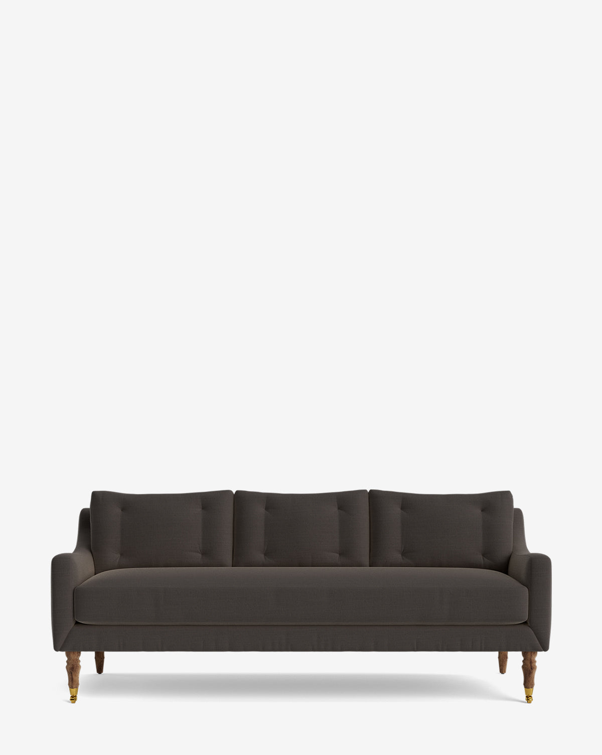 The Barden Sofa 84 is a modern dark gray sofa with three seat cushions, four matching back pillows, slim armrests, and reeded wood legs with brass caster wheels, shown against a plain white background by McGee & Co.