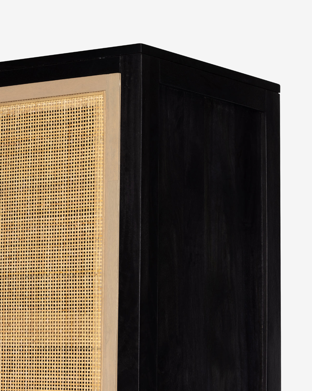 Close-up of the Barney Cabinet in black-washed wood with a natural woven rattan door panel, set against a plain white background; perfect as a modern storage solution with stylish cane doors, by McGee & Co.