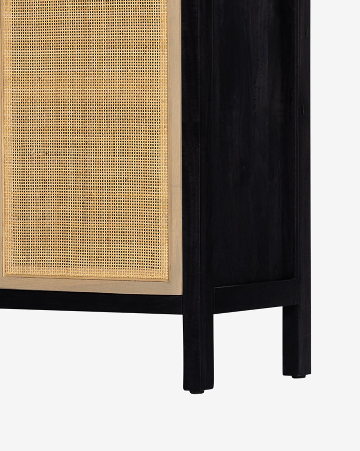 A close-up of the Barney Cabinet showcases its black-washed wood frame and cane doors, emphasizing the striking contrast and rich texture between the woven panels and dark finish, by McGee & Co.