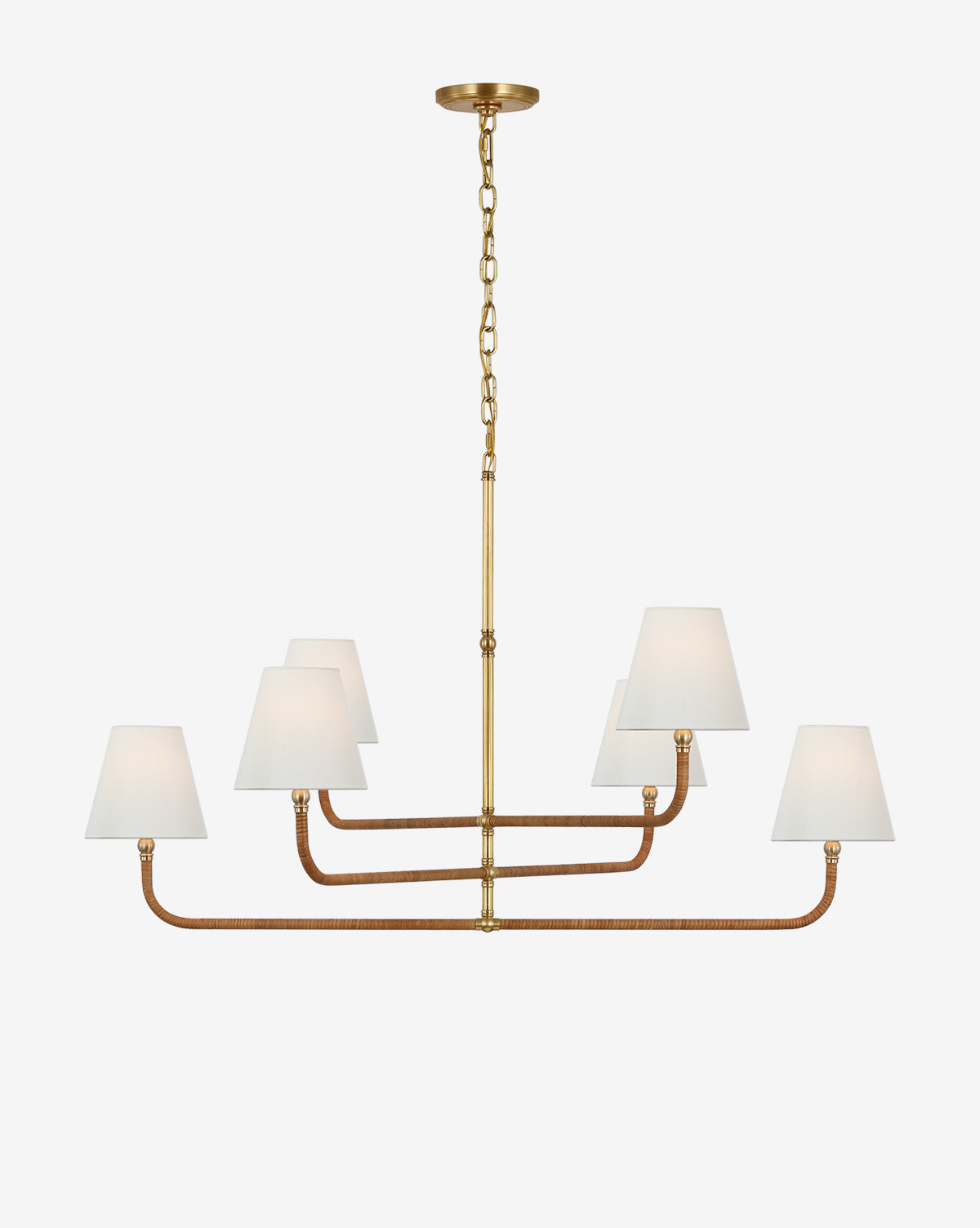 The Basden Three Tier Chandelier by Visual Comfort & Co. Signature features a gold and bronze finish with six white fabric shades in two rows, suspended by a chain—offering a modern take on the classic rattan chandelier. McGee & Co.
