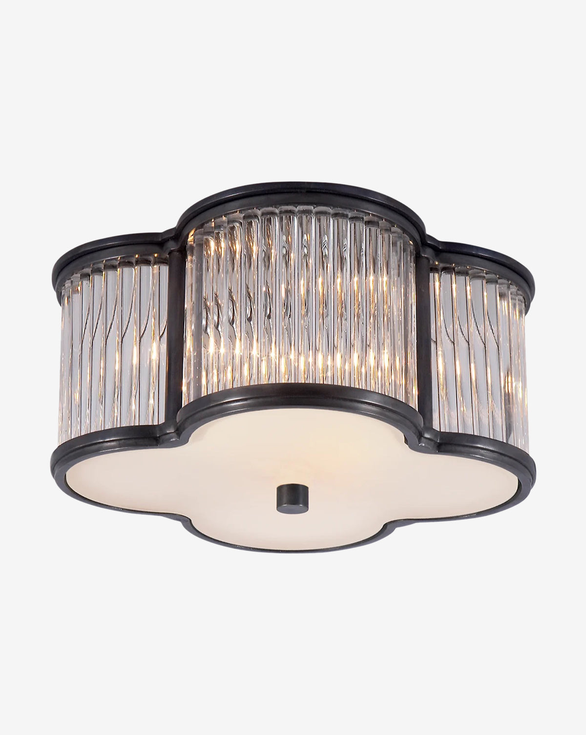 The Basil Flush Mount by Visual Comfort & Co. Signature features a black metal frame, clear ribbed glass panels, and a white frosted glass quatrefoil base, emitting a warm glow. McGee & Co.