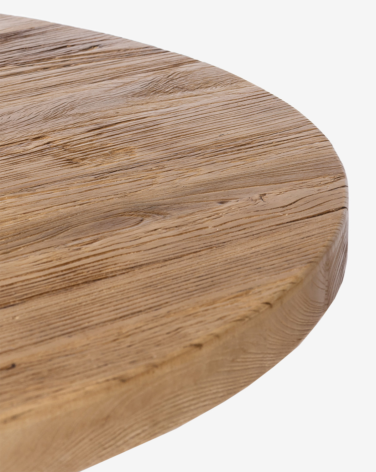 Close-up of the Bayard Round Dining Tables reclaimed elm wood edge, highlighting its natural grain and texture against a plain white background, by McGee & Co.