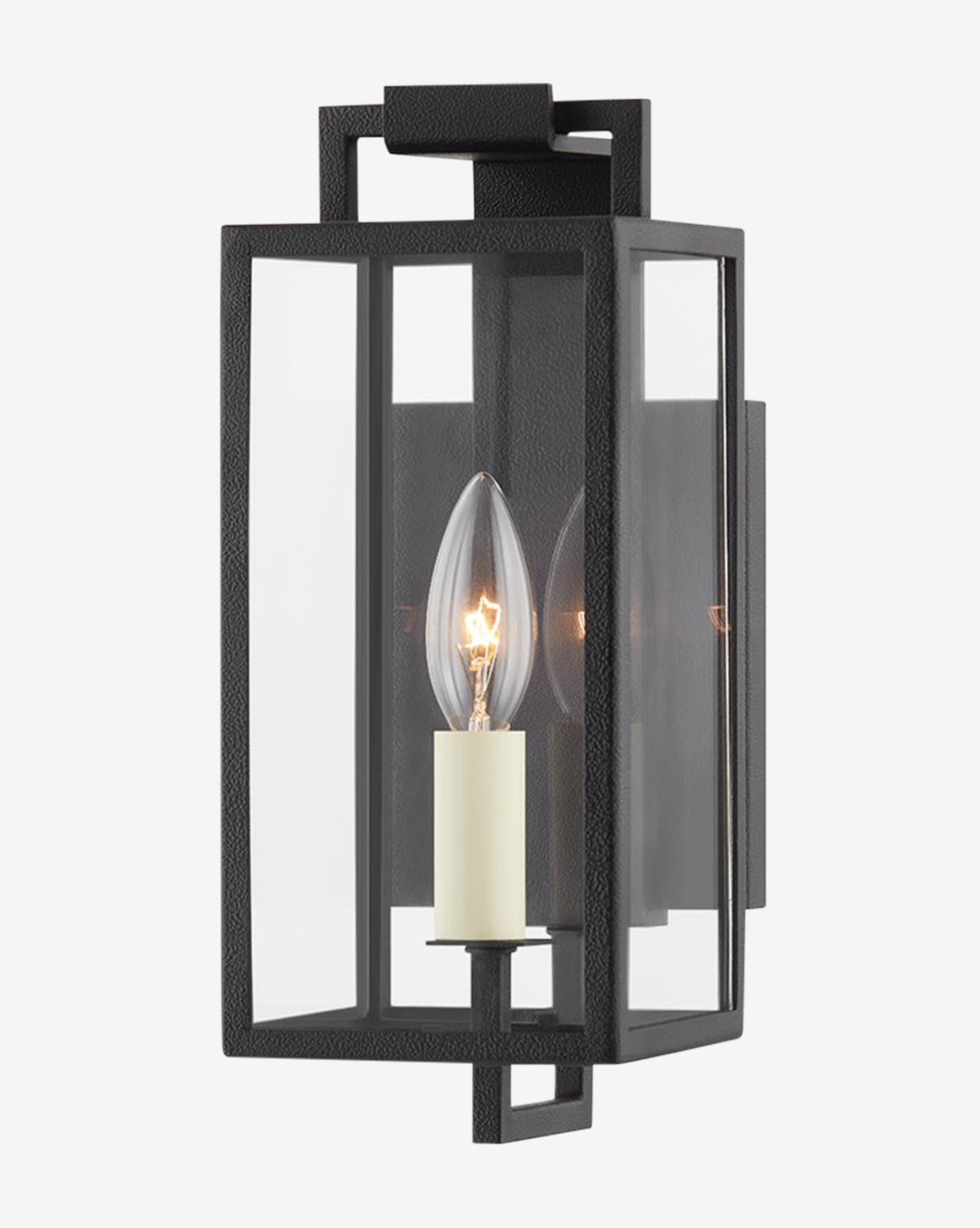 The Beckham Wall Sconce by Troy Lighting features a modern black metal frame, clear glass panels, and an exposed candle-style bulb on a rectangular backplate for sleek industrial charm. McGee & Co.