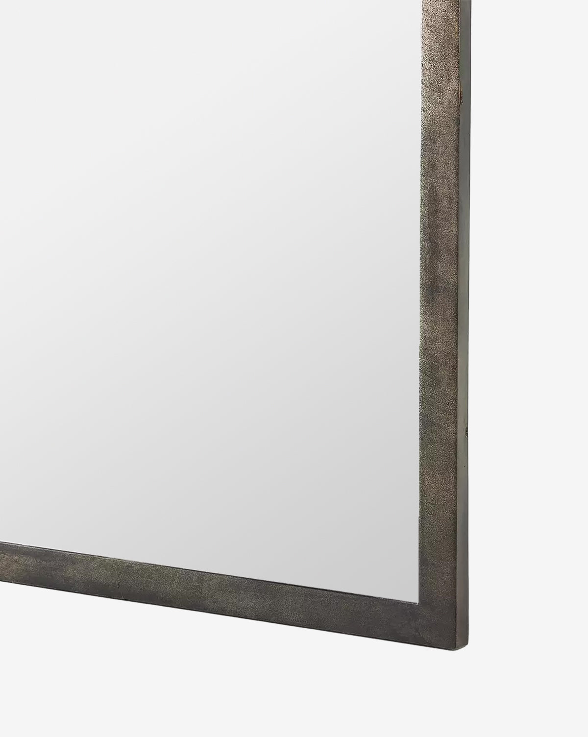 A close-up of the corner of the Beckington Floor Mirror, featuring a textured iron frame in a burnished charcoal finish, set against a plain white background, by McGee & Co.