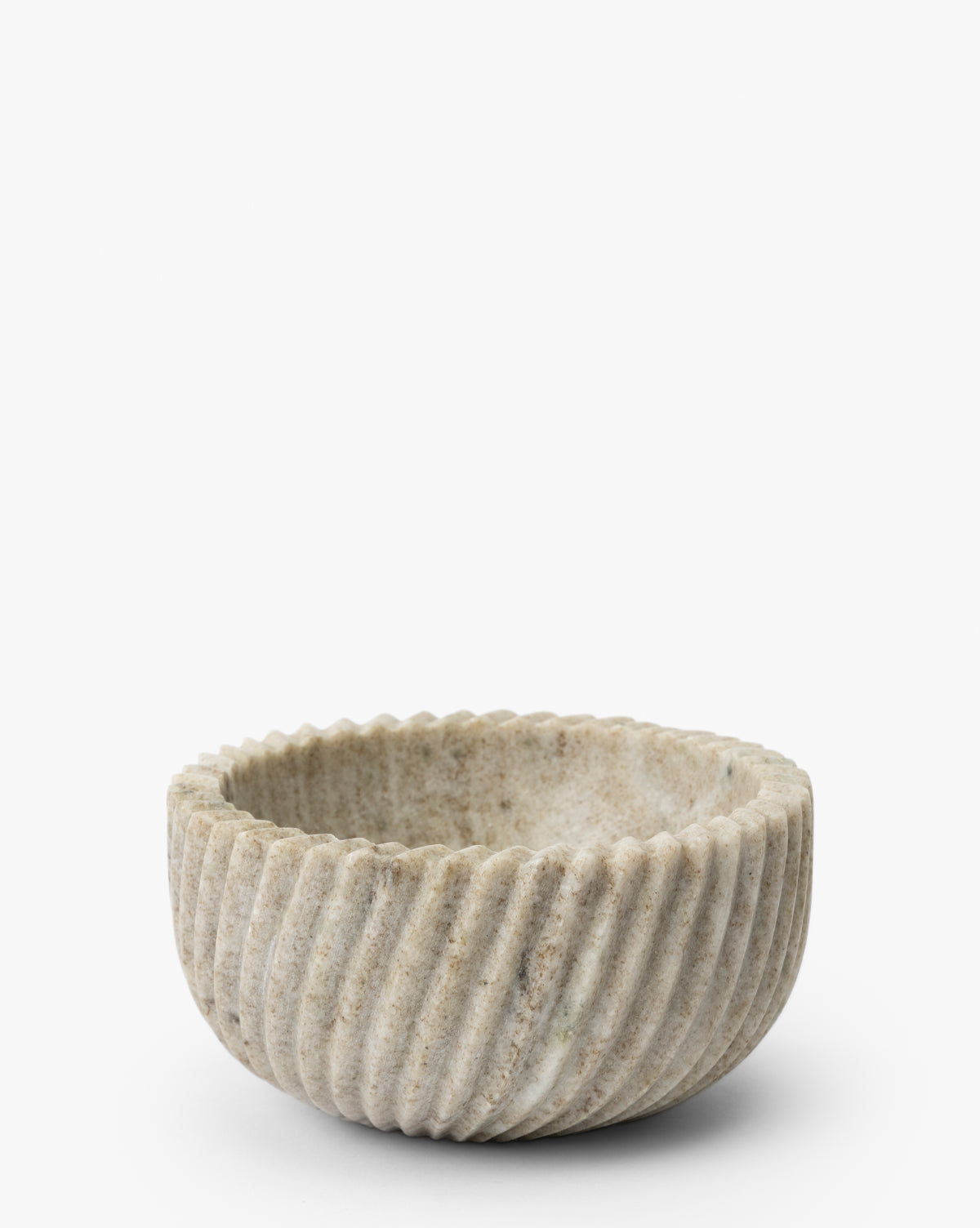 The Beige Spiral Marble Bowl is a round, shallow serving piece with a ribbed spiral texture and natural stone variations, reminiscent of marble. Its light beige color adds elegance, and it’s shown on a plain white background by McGee & Co.